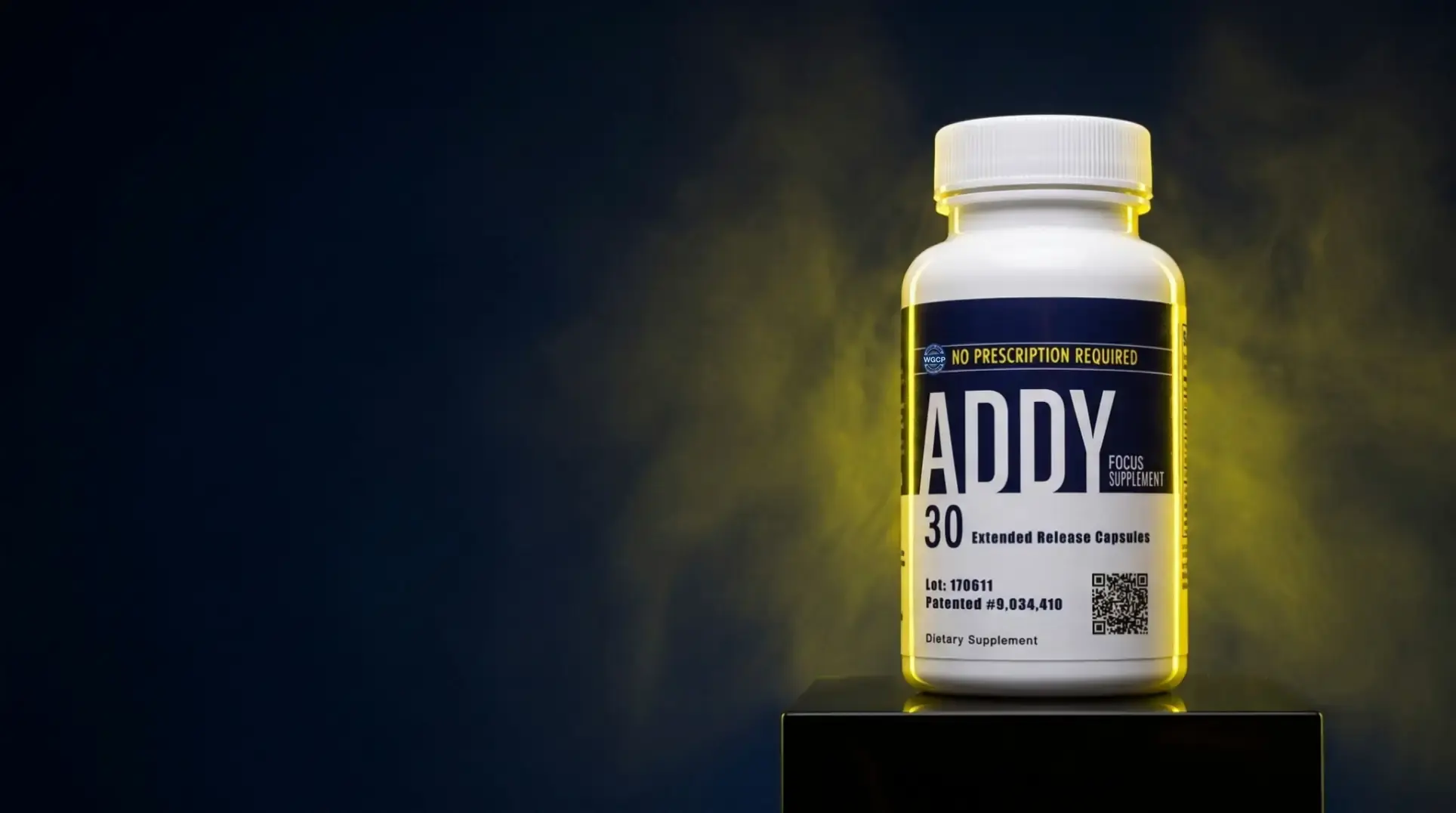 The ADDY 30-count bottle on its black plinth in drifting yellow smoke; as the page scrolls past, it turns on the plinth.